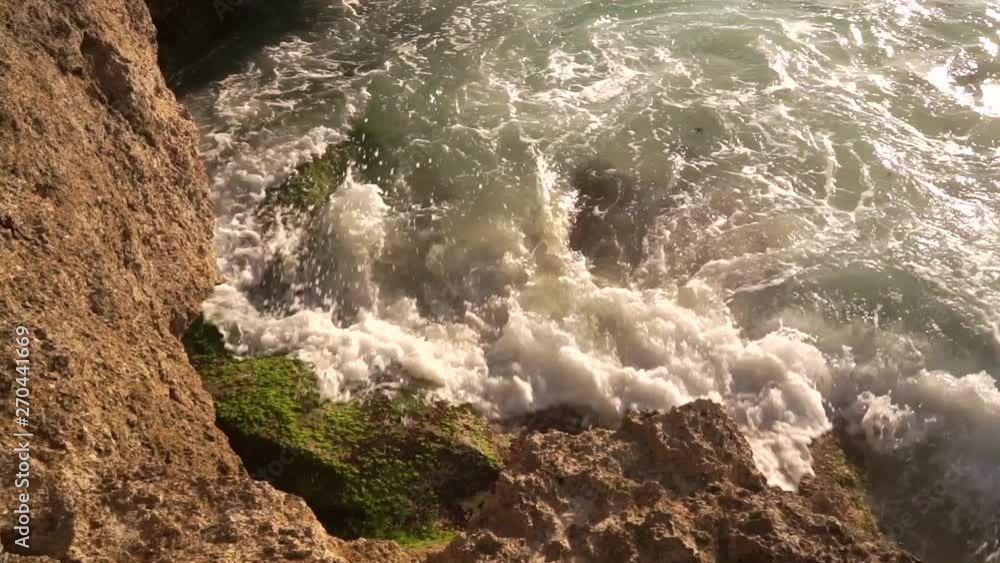 Ocean water breaks on rocks on bright sunny day. Strong frothy waves of turquoise Indian Ocean roll on rocky shore of Nusa Lembongan Island in the Bali region. 50 frames per second full hd footage. Ocean water breaks on rocks on bright sunny day. Strong frothy waves of turquoise Indian Ocean roll on rocky shore of Nusa Lembongan Island in the Bali region. 50 frames per second full hd footage.