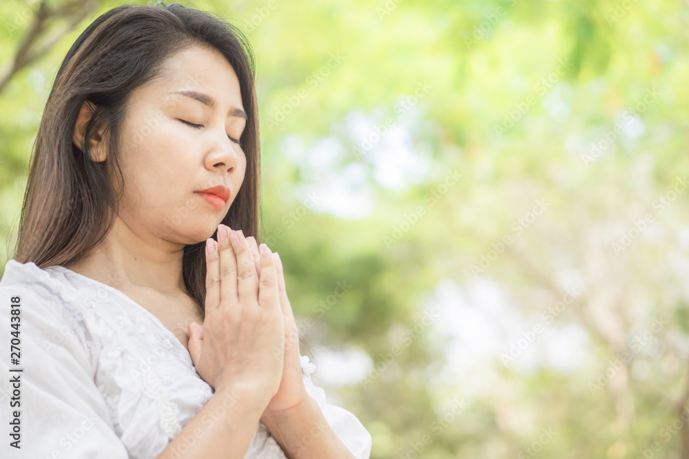 Asian woman praying and doing meditation peaceful outdoor with nature background Asian woman praying and doing meditation peaceful outdoor with nature background