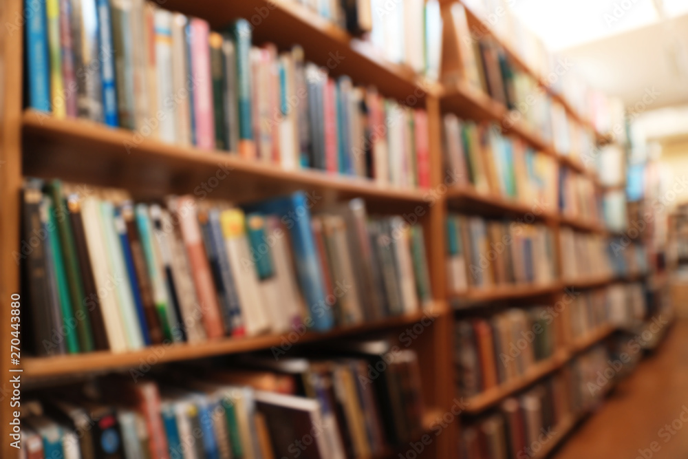 Blurred view of cabinets with books in library Blurred view of cabinets with books in library