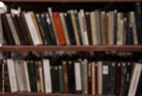 Blurred view of shelves with books in library