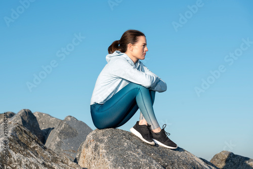 Woman sitting alone outdoors