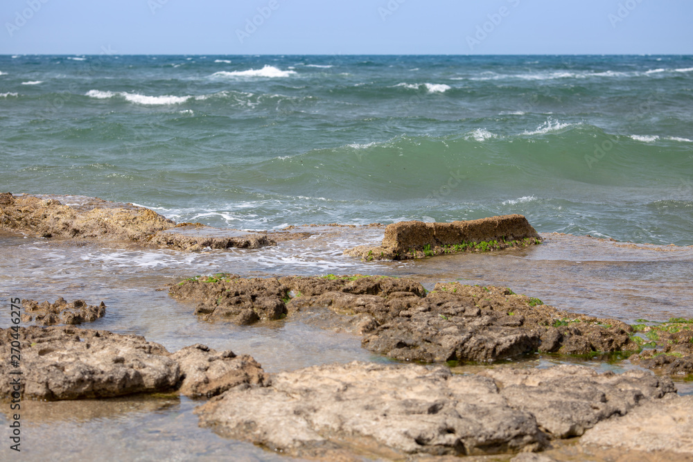 Sea waves and the ruins of the ancient port Sea waves and the ruins of the ancient port