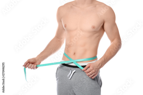 Young man with measuring tape showing his slim body on white background, closeup