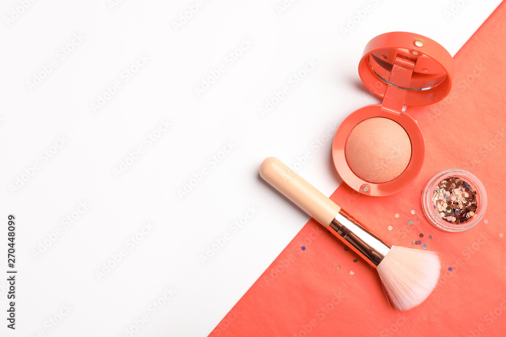 Flat lay composition with coral blush, glitter and makeup brush on color background. Space for text Flat lay composition with coral blush, glitter and makeup brush on color background. Space for text