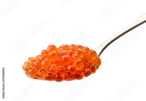 Spoon of salted salmon caviar carved on a white background.