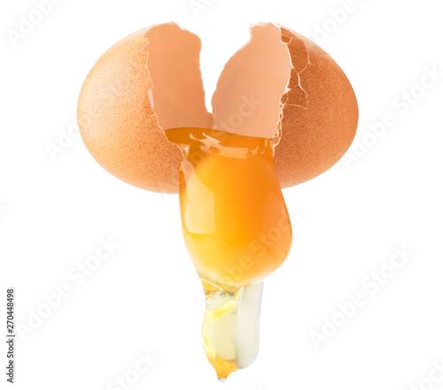 Foto Chicken egg broken in half, follows yolk and protein on a white, isolated