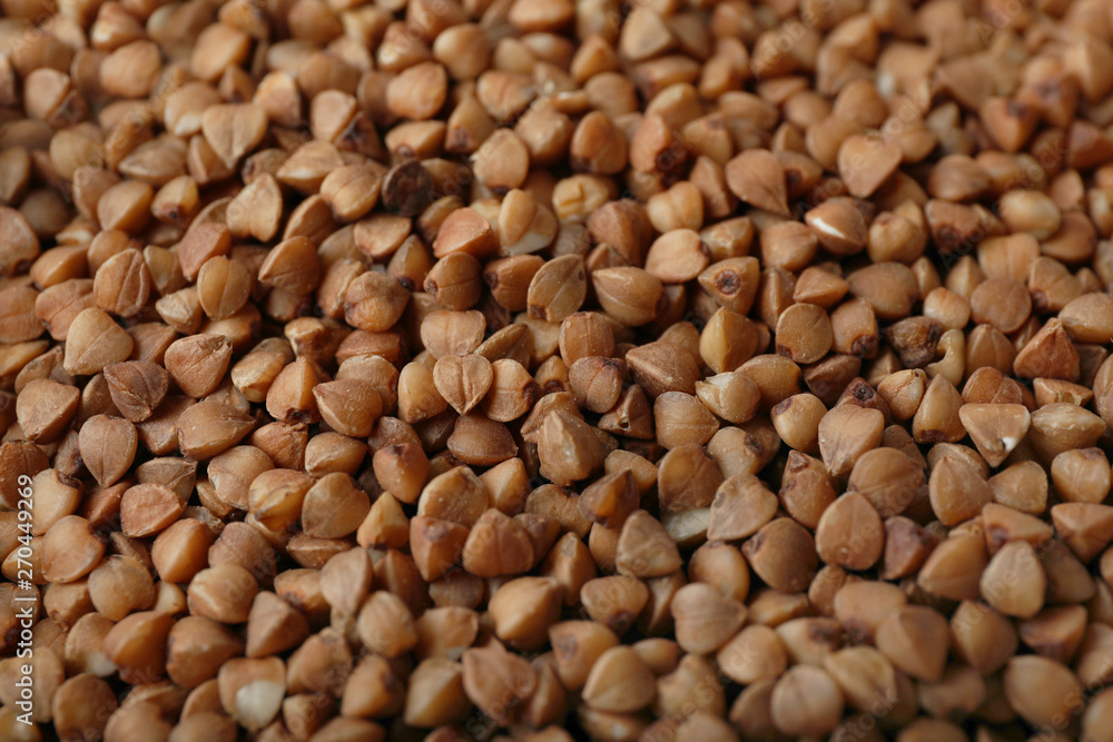 Uncooked buckwheat as background, closeup. Organic wholesome product Uncooked buckwheat as background, closeup. Organic wholesome product