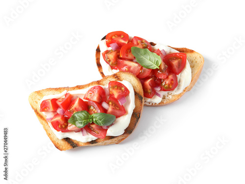 Tasty bruschettas with tomatoes on white background, top view