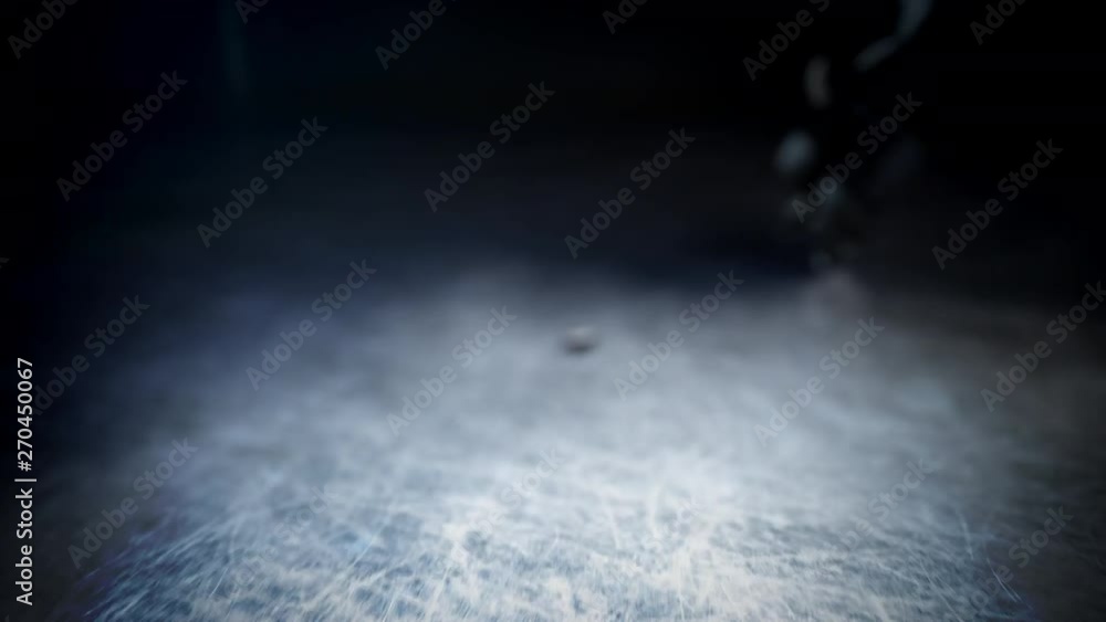 Hockey player in black uniform hits the puck in slow motion Hockey player in black uniform hits the puck in slow motion