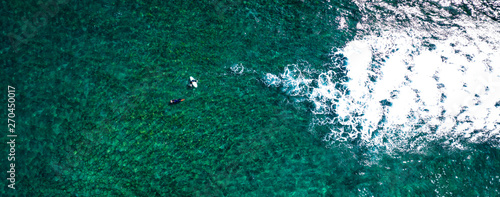 Aerial view of surfers on ocean and summer time 