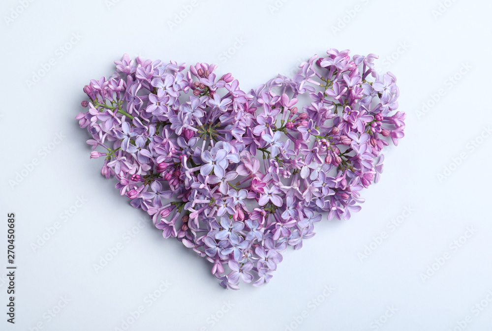 Fototapeta premium Heart made of blossoming lilac on light background, flat lay. Spring flowers