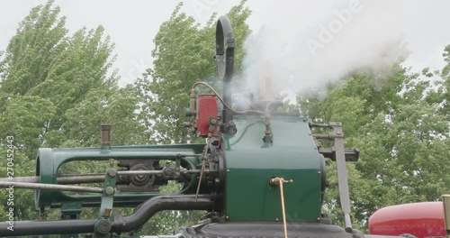 Close shot steam roler with lots of white steam.