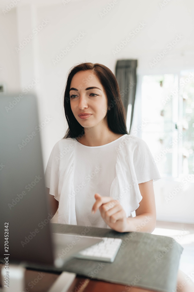 Young woman using her laptop at home Young woman using her laptop at home