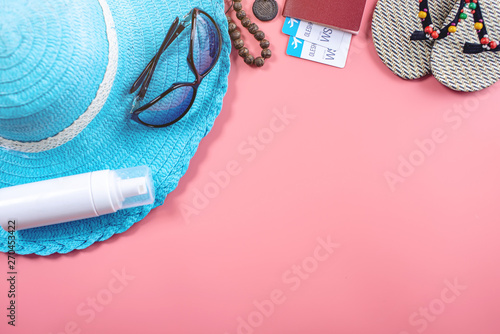 Travel holiday supplies: hat, sunglasses, passport on pink background. Concept of going on vacation at sea. Top view