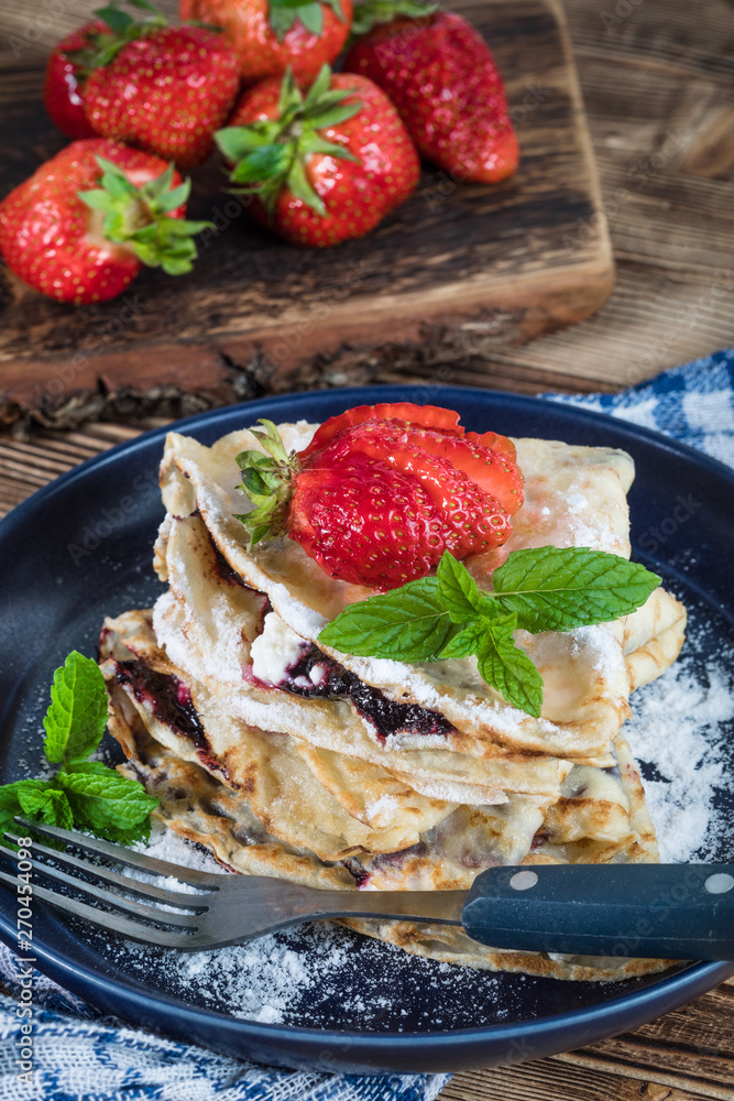 Polish pancakes with jam, cheese and strawberries. Polish pancakes with jam, cheese and strawberries.