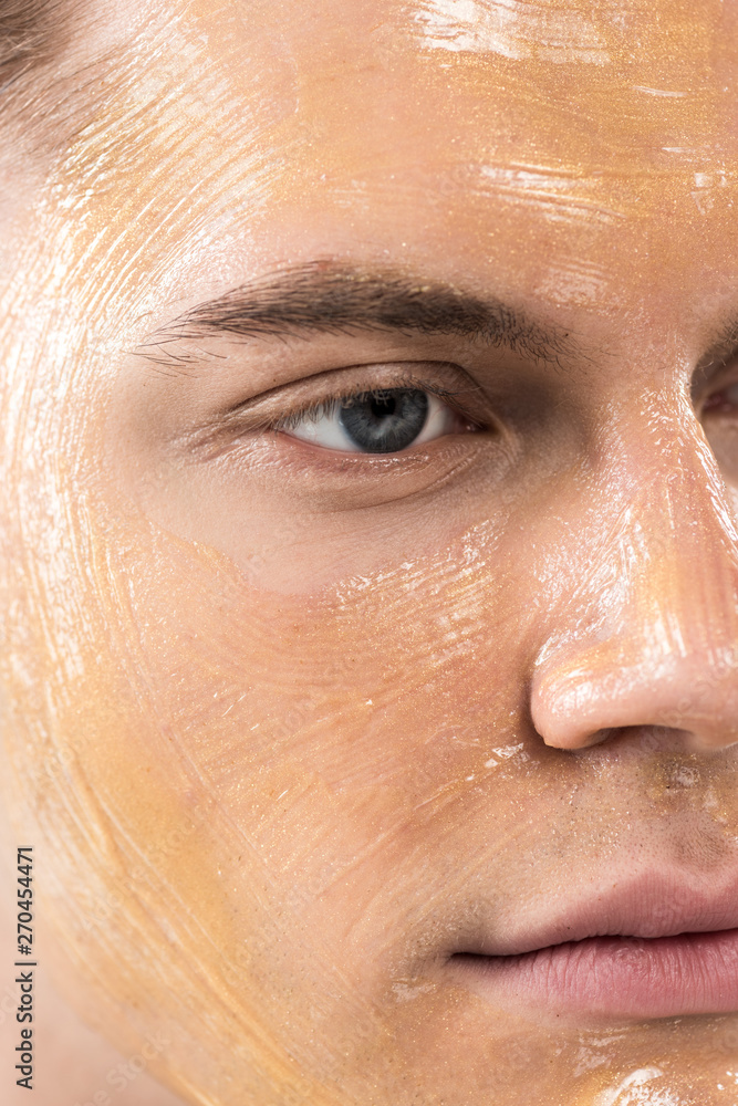 close up view of young man with facial mask