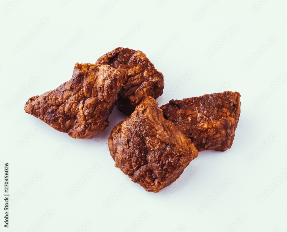 Fried sauteed beef tenderlion cubes isolated on white background Fried sauteed beef tenderlion cubes isolated on white background