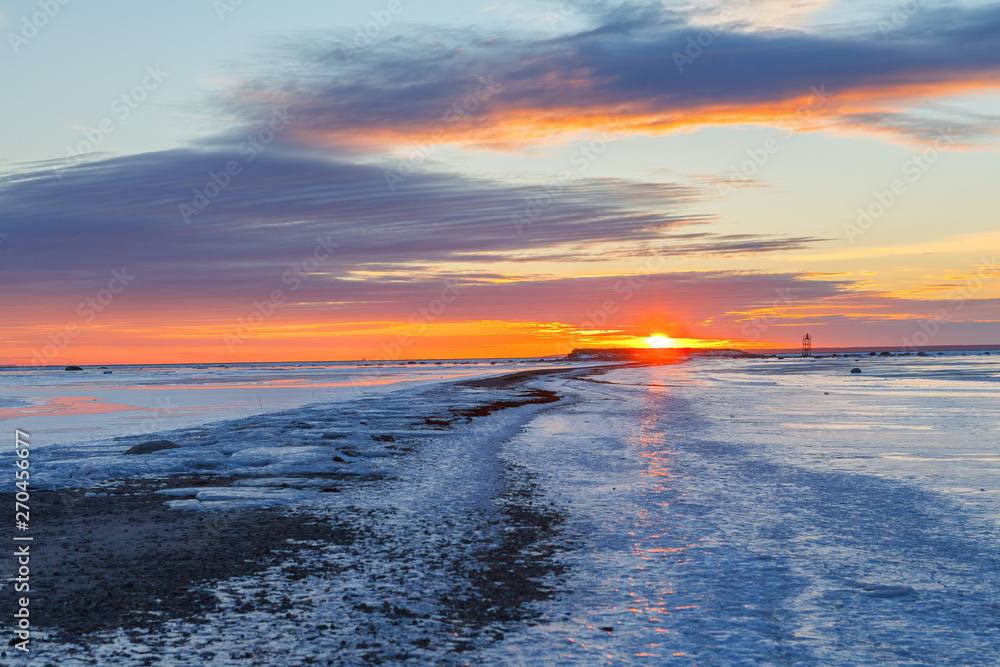 Sunset over long peninsula in shallow Baltic sea, frosty winter time. Path to the sun. Sunset over long peninsula in shallow Baltic sea, frosty winter time. Path to the sun.