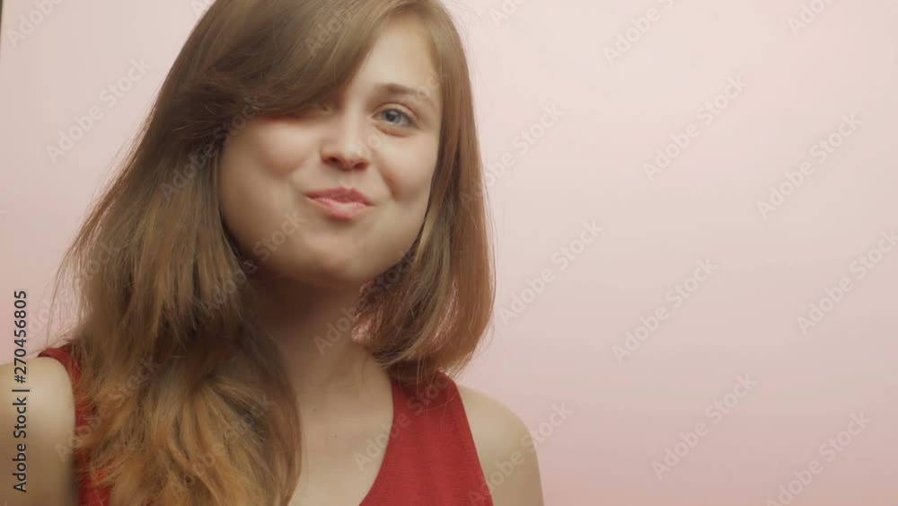 young girl on the color studio background with an appetite eating an apple, a young woman bites fruit and chews, food concept young girl on the color studio background with an appetite eating an apple, a young woman bites fruit and chews, food concept