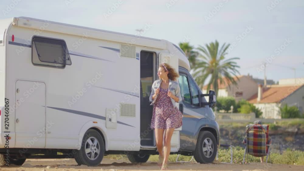 Adventure travel in motorhome. Traveling woman by mobile motor home RV campervan. Adventure travel in motorhome. Traveling woman by mobile motor home RV campervan.