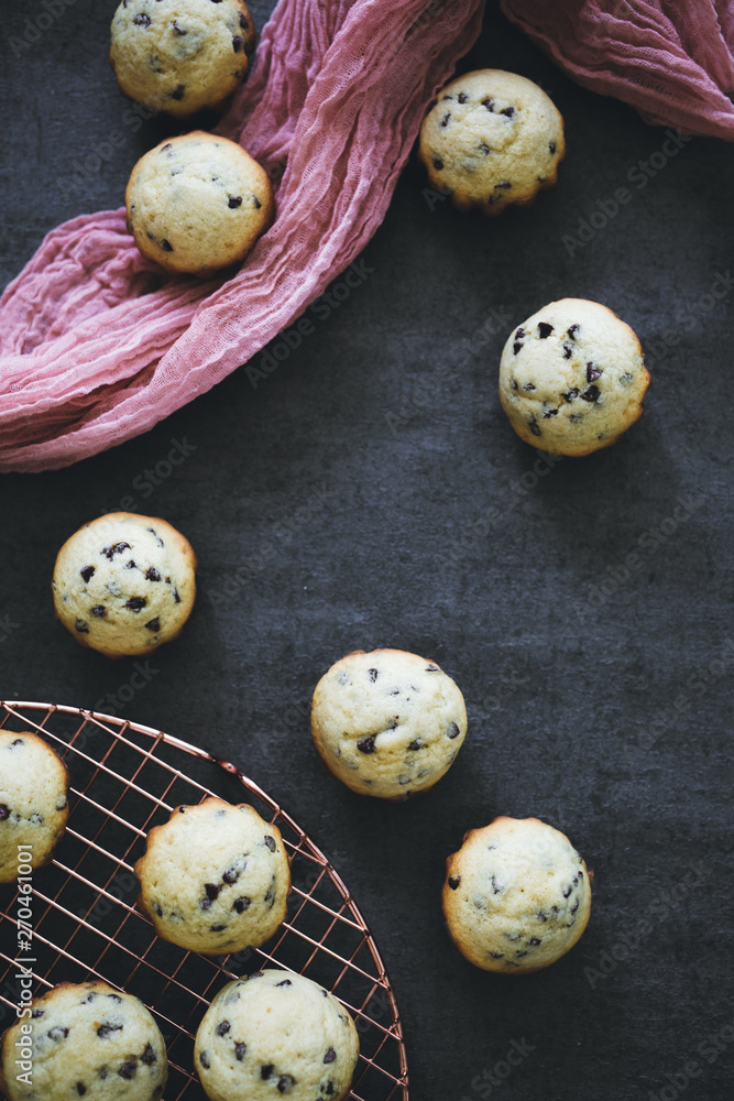 Obraz premium Flat Lay of Mini Blueberry Muffins on Dark Background