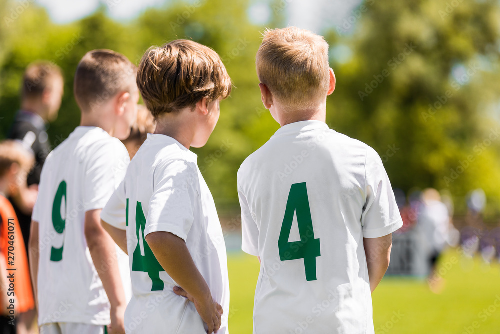 Children Sports Team Members. Junior Soccer Players on Substitution Bench.  Kids in White Jersey Shirts with Green Numbers on its Back Stock Photo |  Adobe Stock
