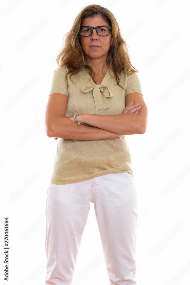 Studio shot of mature beautiful woman standing and wearing eyegl Studio shot of mature beautiful woman standing and wearing eyegl