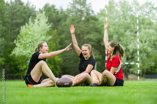 Pretty american football players celebrating their win on a sunny day