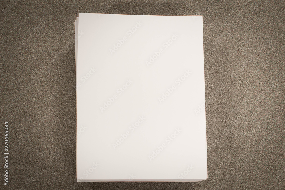 Stack of blank paper on desk Stack of blank paper on desk