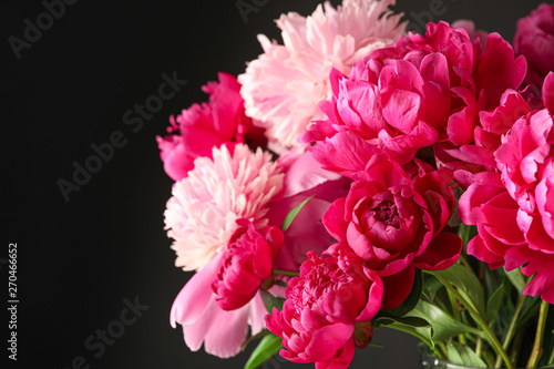 Bouquet of beautiful pink peonies against dark background  space for text