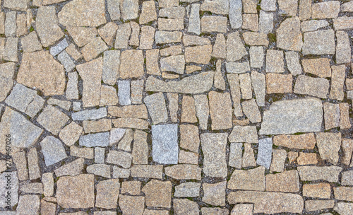 Old road paved with granite stones.
