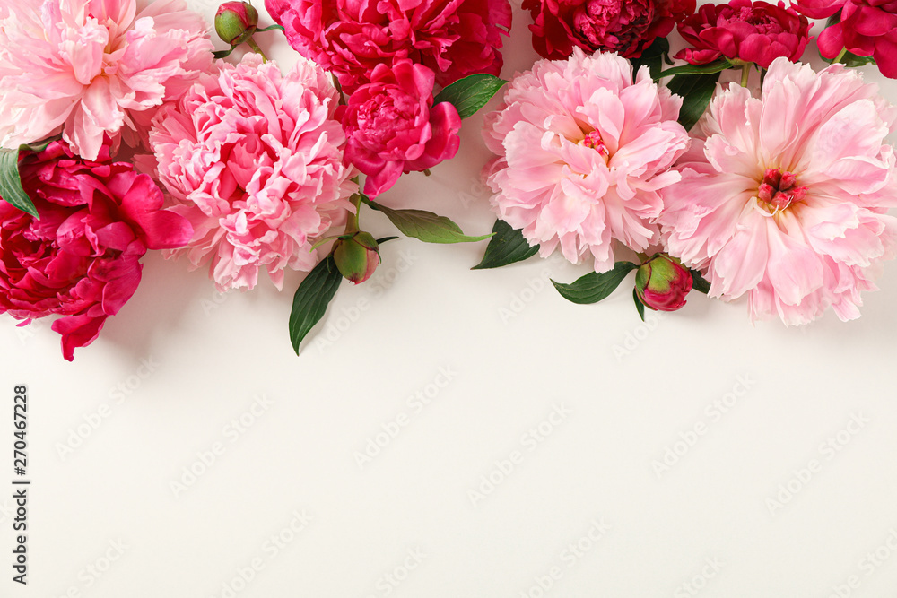 Flat lay composition with beautiful peonies on white background, space for text and top view