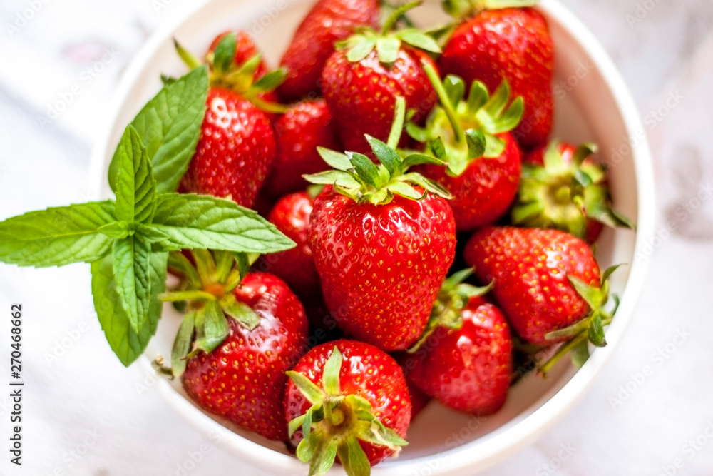 Tasty juicy strawberries on a white plate Tasty juicy strawberries on a white plate