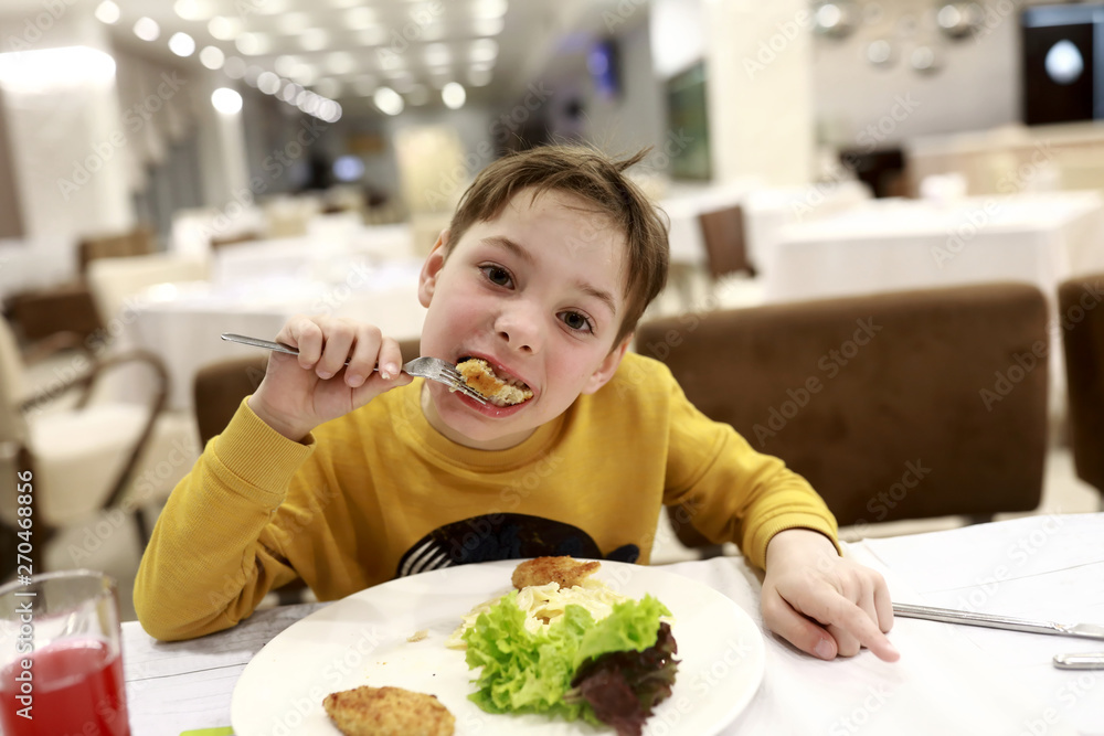Boy eating chicken cutlet Boy eating chicken cutlet
