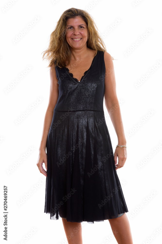 Studio shot of mature happy woman smiling and standing