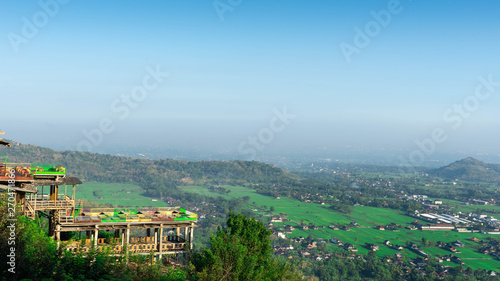 Aerial city view from a hill in the morning with a blue sky background