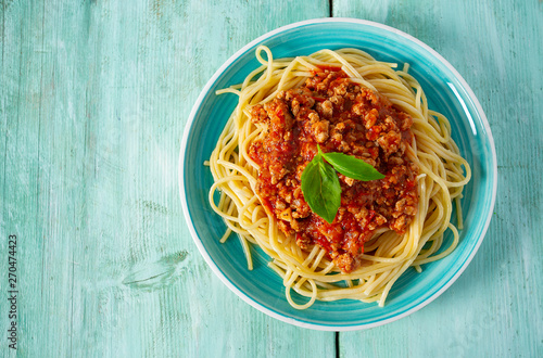 Canvas Print spaghetti bolognese on wooden surface