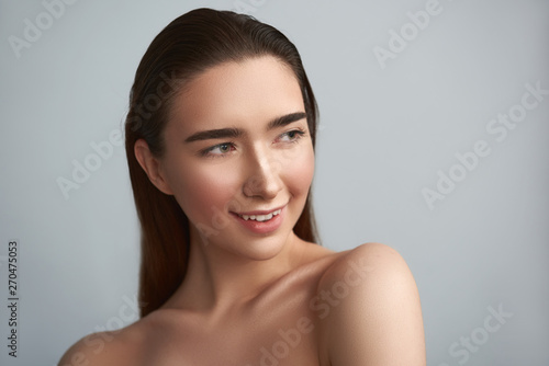 Happy naked woman is isolated on grey background