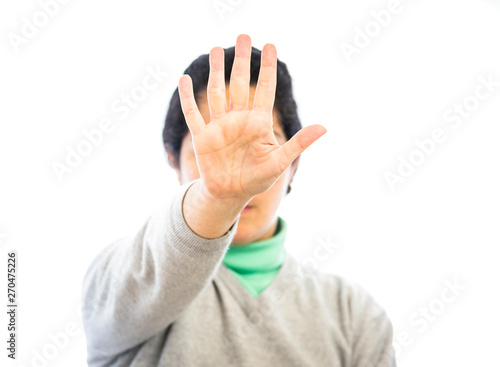 Woman reaching out in self-defense or asking for help. Concept of stopping violence or domestic violence Portrait of a girl showing her hand at a stop sign, with the palm of her hand focused