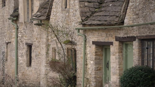 Close up footage of old stone house in famous road in village Bibury. photo