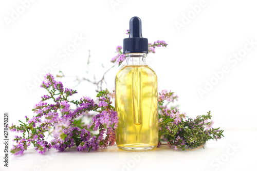 Calluna essential oil in  beautiful bottle on White background