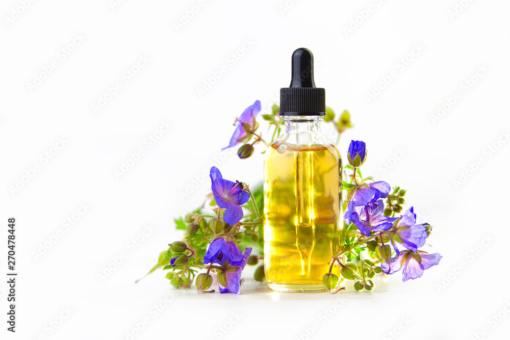 meadow geranium essential oil in beautiful bottle on White background meadow geranium essential oil in beautiful bottle on White background