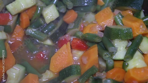 cooking vegetables for a dish of vegetables with seafood in an iron pan photo