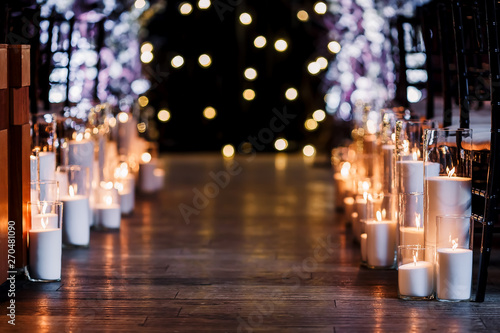 Wedding ceremony decorations in loft grunge surround. Light bulb garland, candles, glass, chairs and candlesticks. Ceremony in purple color. Exit registration inside.