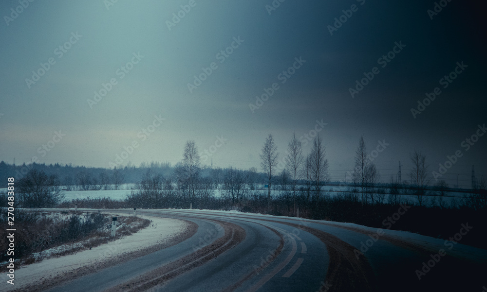 Russian asphalt road in winter. winter road.