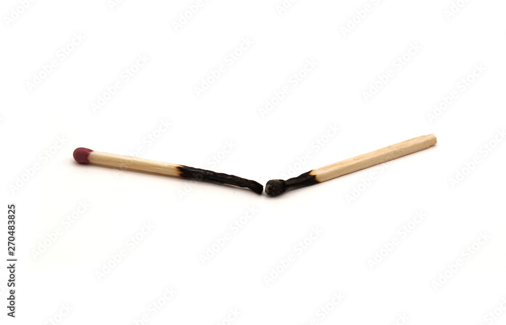 two burnt matches on a white background two burnt matches on a white background