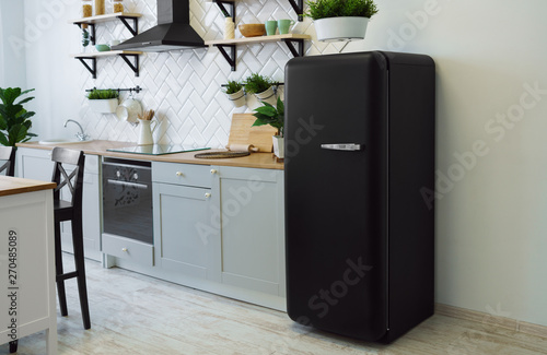Retro style black fridge in gray wooden kitchen photo