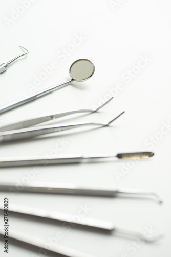 a various dental tools laid out flatlay on a light background