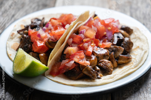 Vegan and vegetarian mexican mushrooms tacos with sauce and lime