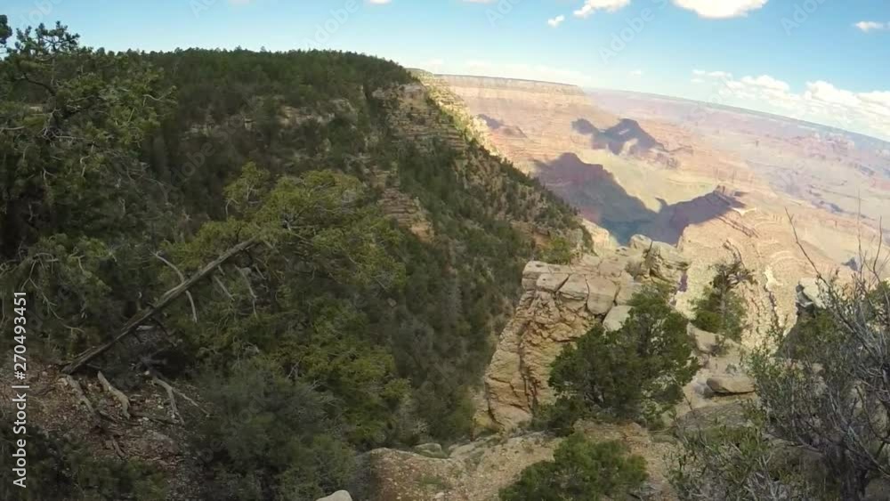 Woman sitting on a cliff of Grand Canyon Woman sitting on a cliff of Grand Canyon